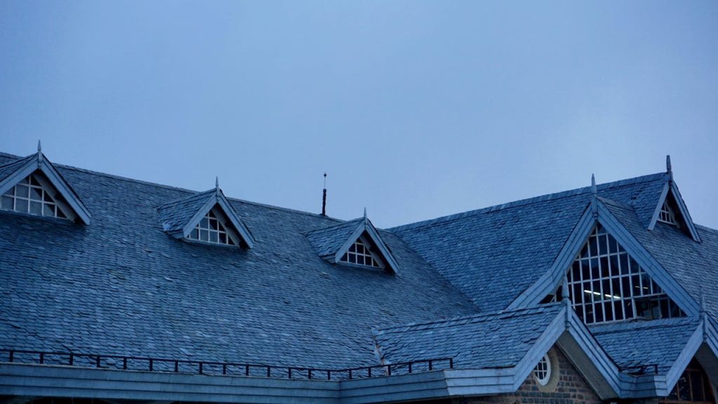 A contemporary rooftop with unique architectural elements set against a deep blue evening sky.